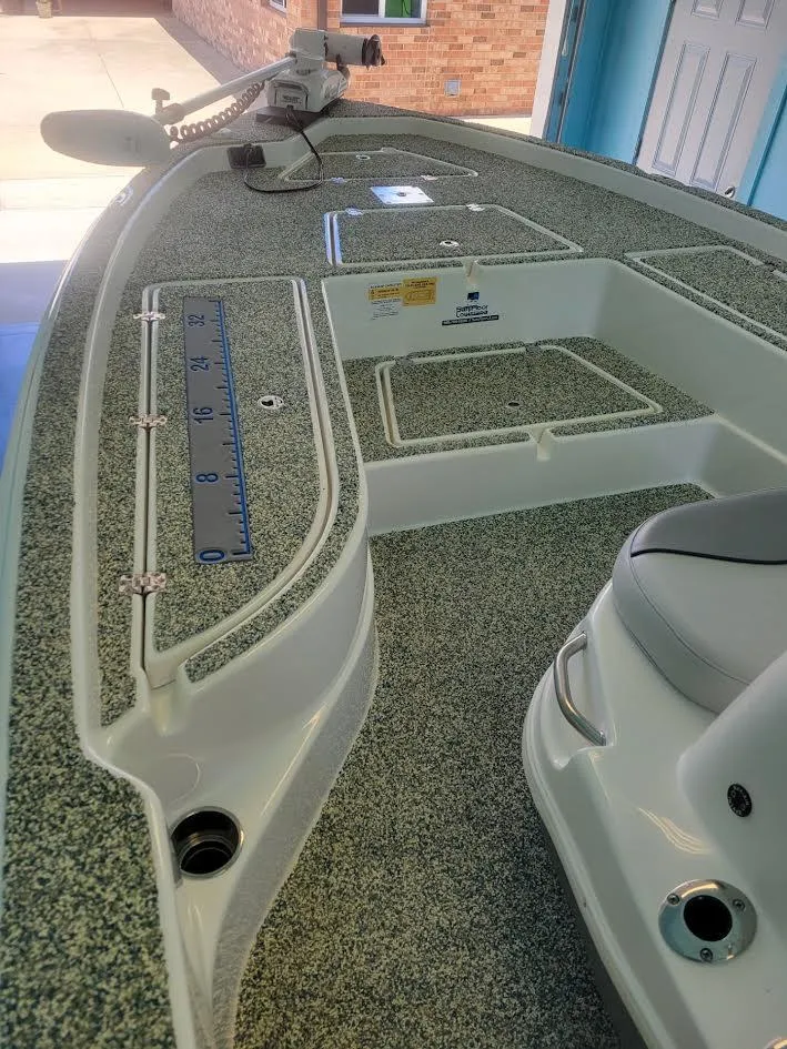 Slide: The Image of 2021 NauticStar 215 XTS boat deck with seating and measurement ruler. - 7