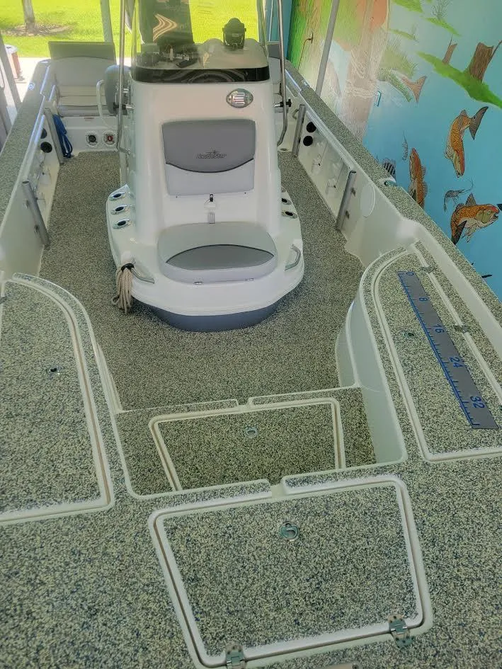 Slide: The Image of 2021 NauticStar 215 XTS boat interior with textured flooring and console. - 8
