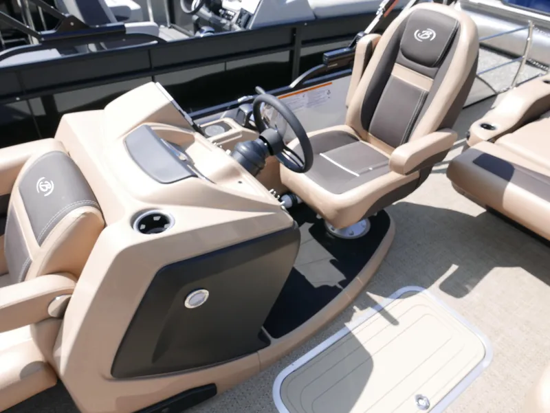 Slide: The Image of 2025 Barletta Cabrio 24UC boat interior with beige and brown captain's seat and steering console. - 15