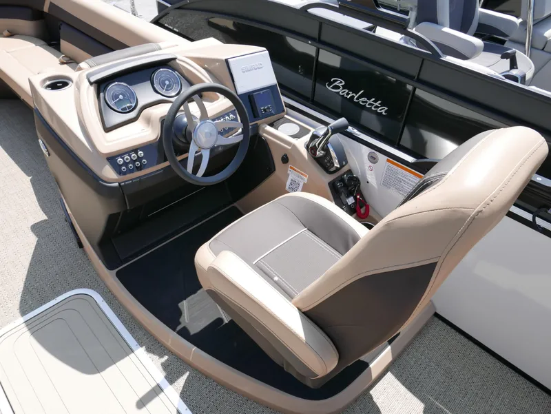 Slide: The Image of 2025 Barletta Cabrio 24UC boat interior with modern steering console and comfortable seating. - 16