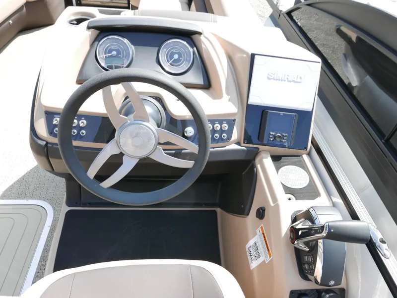 Slide: The Image of 2025 Barletta Cabrio 24UC boat dashboard with steering wheel and control panel. - 17