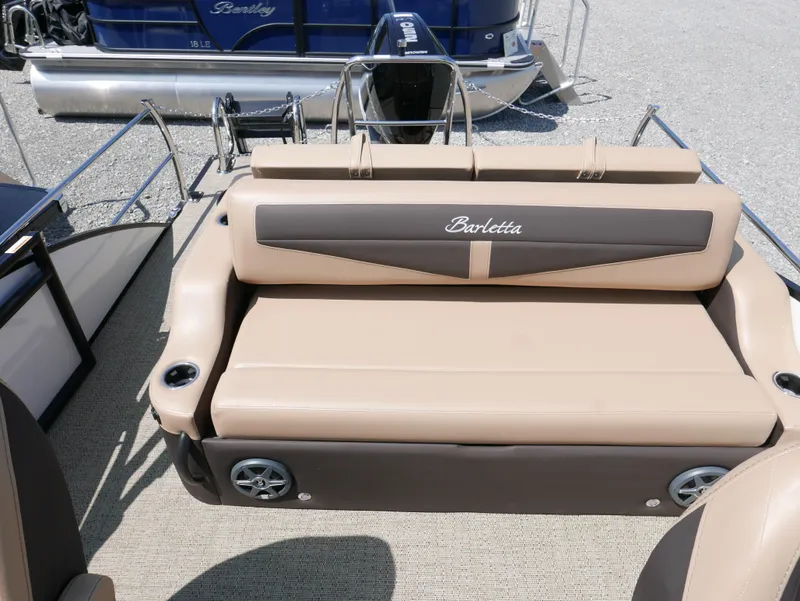 Slide: The Image of 2025 Barletta Cabrio 24UC boat seating with beige upholstery and cup holders. - 19