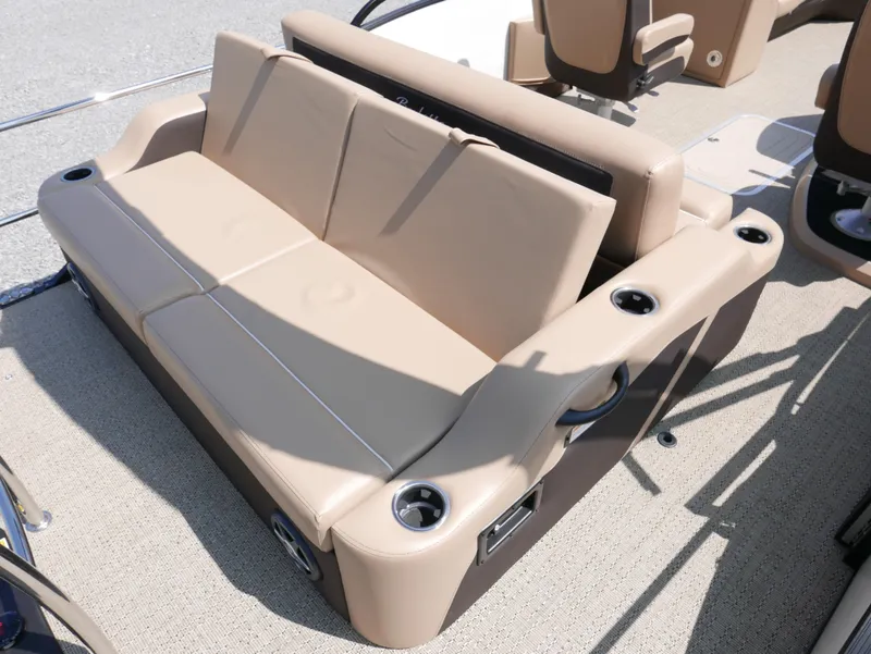 Slide: The Image of 2025 Barletta Cabrio 24UC boat seating with beige upholstery and cup holders. - 21