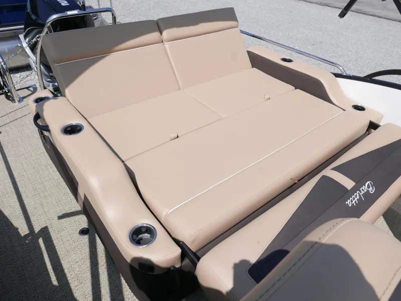Slide: The Image of 2025 Barletta Cabrio 24UC boat with beige seating and cup holders. - 22