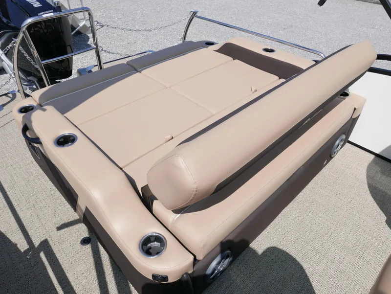 Slide: The Image of 2025 Barletta Cabrio 24UC boat with beige seating and cup holders. - 26