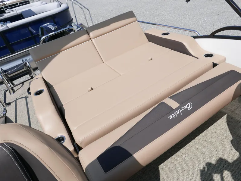 Slide: The Image of 2025 Barletta Cabrio 24UC boat with beige seating and cup holders. - 28