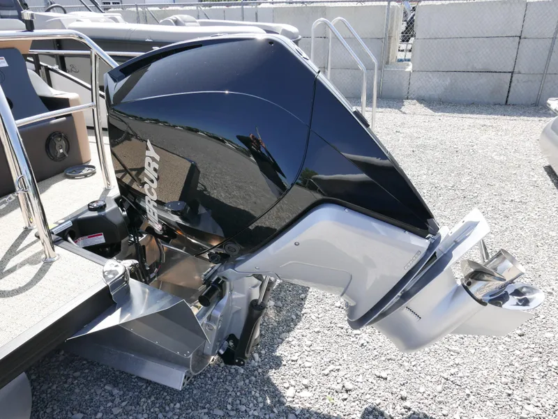 Slide: The Image of 2025 Barletta Cabrio 24UC boat with Mercury outboard motor, parked on gravel. - 4