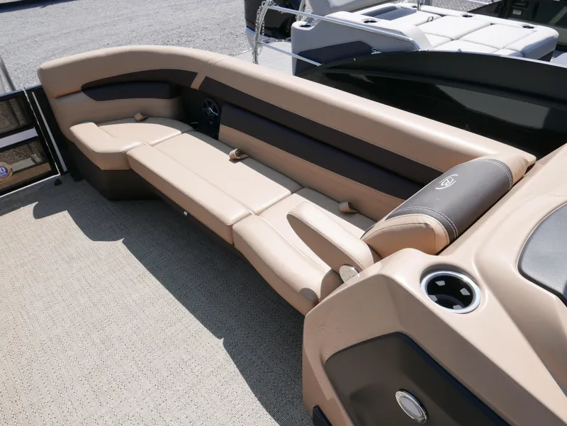 Slide: The Image of 2025 Barletta Cabrio 24UC boat interior with beige seating and cup holder. - 7