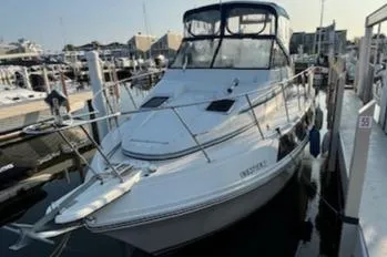 Slide: The Image of 1989 Carver 32 Mariner docked at marina, featuring sleek design and spacious deck. - 12