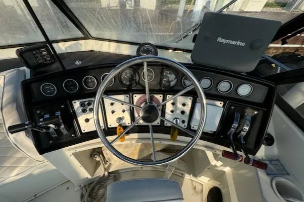 Slide: The Image of Cockpit of 1989 Carver 32 Mariner with steering wheel and navigation equipment. - 16