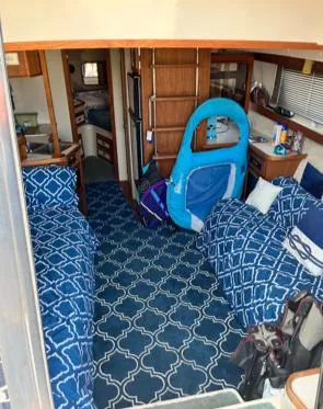 Slide: The Image of Interior of 1989 Carver 32 Mariner with blue patterned decor and twin beds. - 2