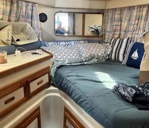 Slide: The Image of Interior cabin of 1989 Carver 32 Mariner with cozy bedding and nautical decor. - 3