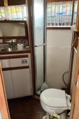 Slide: The Image of 1989 Carver 32 Mariner bathroom with sink, shower, and toilet. - 4