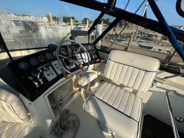 Slide: The Image of 1989 Carver 32 Mariner helm with steering wheel and control panel. - 7