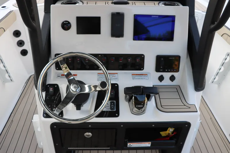 Slide: The Image of 2025 Yamaha Boats 222FSH SPORT E dashboard with steering wheel and control panel. - 10