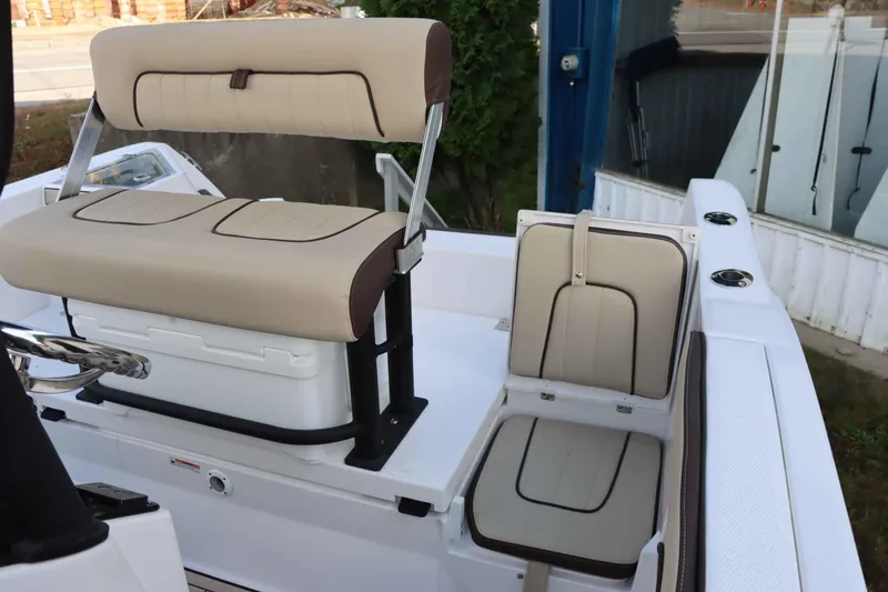 Slide: The Image of 2025 Yamaha Boats 222FSH SPORT E interior seating with beige and brown upholstery. - 11