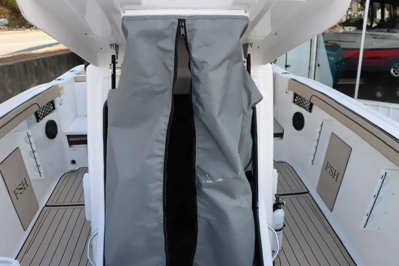 Slide: The Image of 2025 Yamaha Boats 222FSH SPORT E interior with protective cover and deck view. - 17