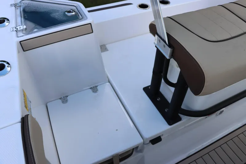 Slide: The Image of 2025 Yamaha Boats 222FSH SPORT E interior seating and storage area. - 18