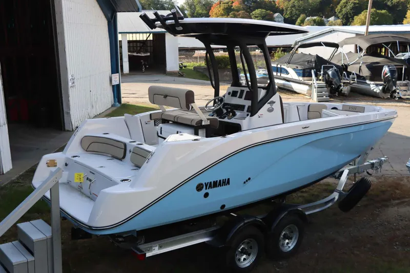 Slide: The Image of 2025 Yamaha Boats 222FSH SPORT E in light blue, docked outdoors. - 5