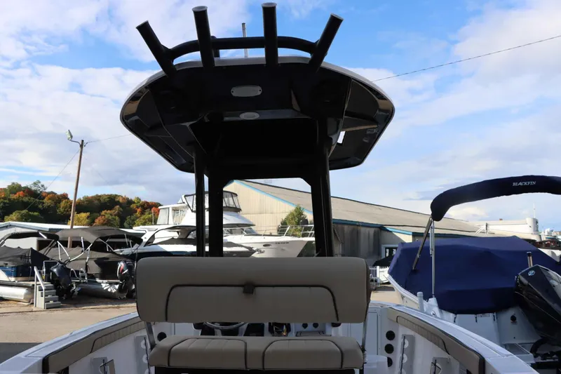 Slide: The Image of 2025 Yamaha Boats 222FSH SPORT E at marina, surrounded by other boats. - 7