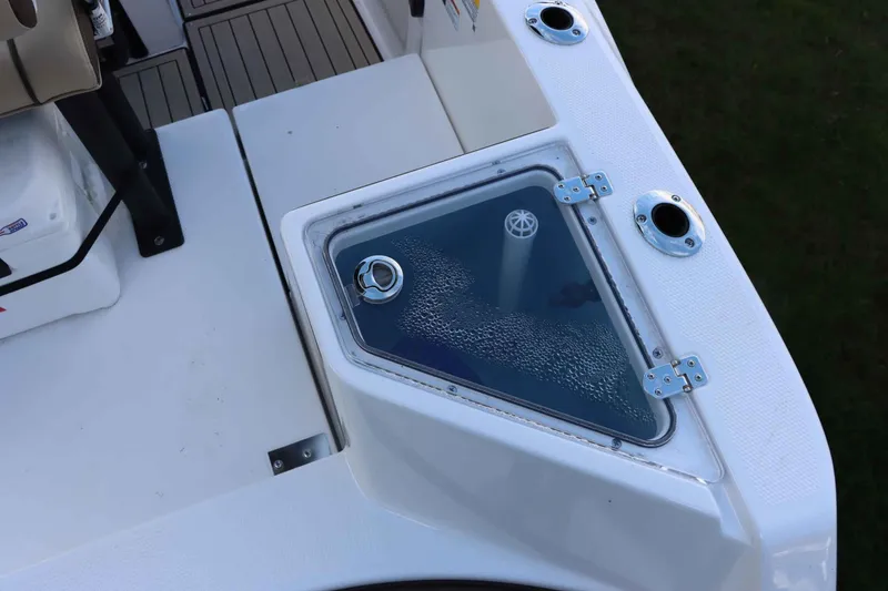 Slide: The Image of 2025 Yamaha Boats 222FSH SPORT E livewell with clear lid and rod holders. - 8