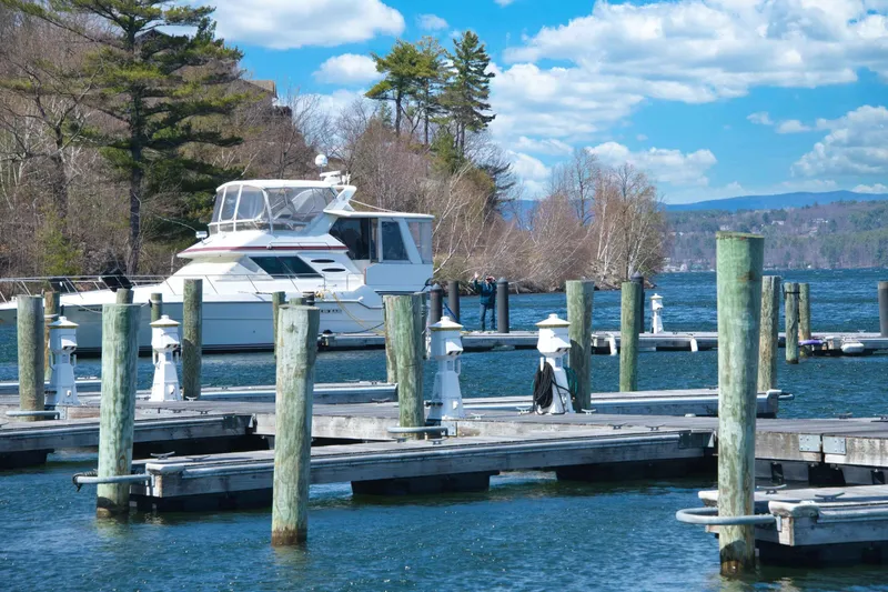 Slide: The Image of 1989 Sea Ray 440 Aft Cabin yacht docked at a scenic marina. - 13