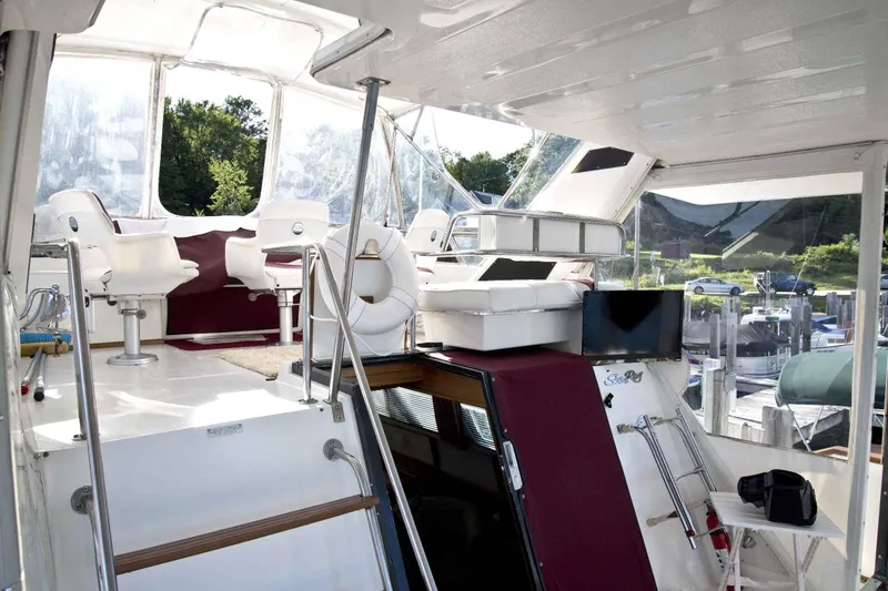 Slide: The Image of 1989 Sea Ray 440 Aft Cabin yacht interior with seating and helm station. - 15