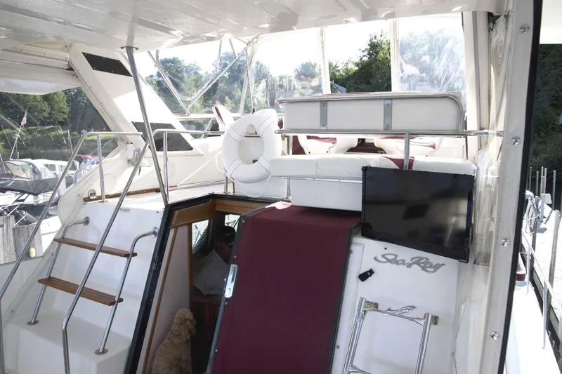 Slide: The Image of 1989 Sea Ray 440 Aft Cabin yacht with outdoor seating and TV. - 16