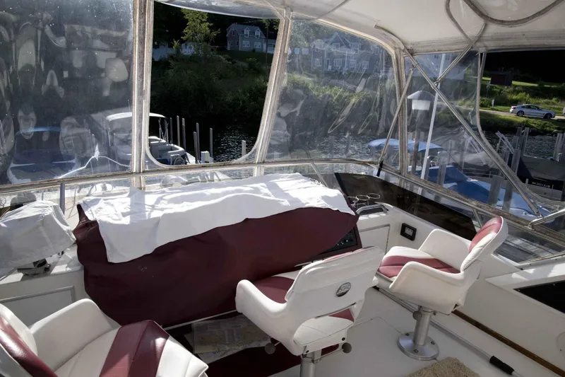 Slide: The Image of Interior of 1989 Sea Ray 440 Aft Cabin yacht with helm and seating area. - 17