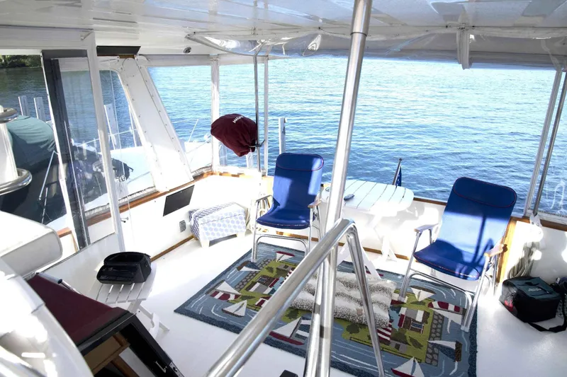 Slide: The Image of 1989 Sea Ray 440 Aft Cabin interior with blue chairs and nautical-themed decor. - 19