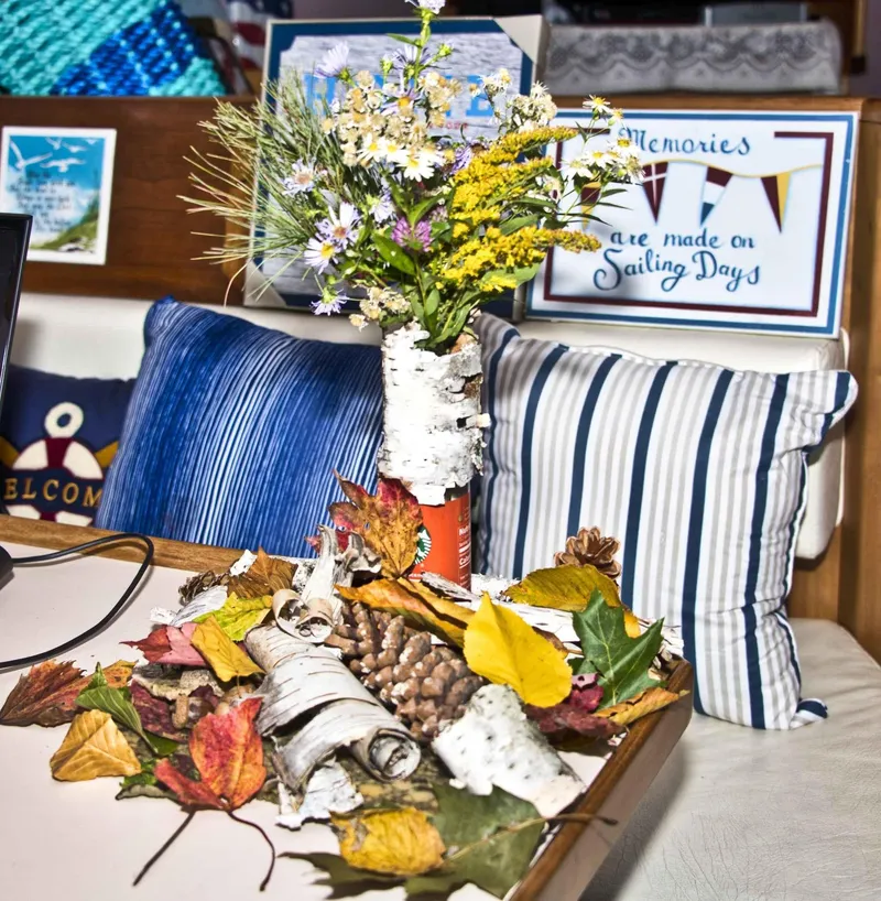 Slide: The Image of Cozy Sea Ray 440 Aft Cabin interior with autumn decor and nautical-themed pillows. - 29