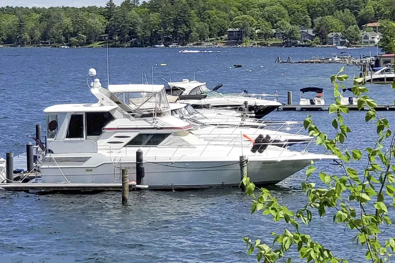 Slide: The Image of 1989 Sea Ray 440 Aft Cabin yacht docked on a scenic lake. - 4