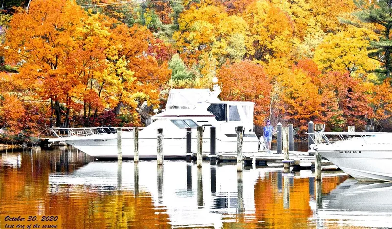 Slide: The Image of 1989 Sea Ray 440 Aft Cabin docked amid vibrant autumn foliage. - 5