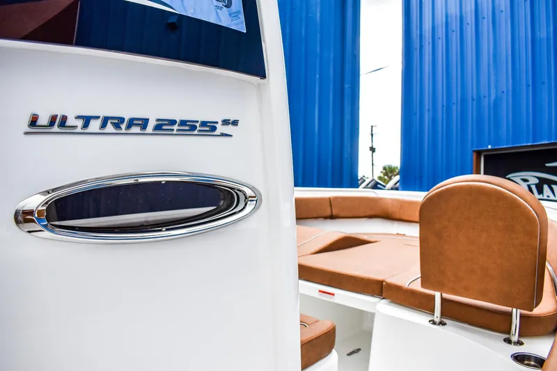 Slide: The Image of 2025 Sea Hunt Ultra 255 SE boat with tan seating and sleek design. - 10