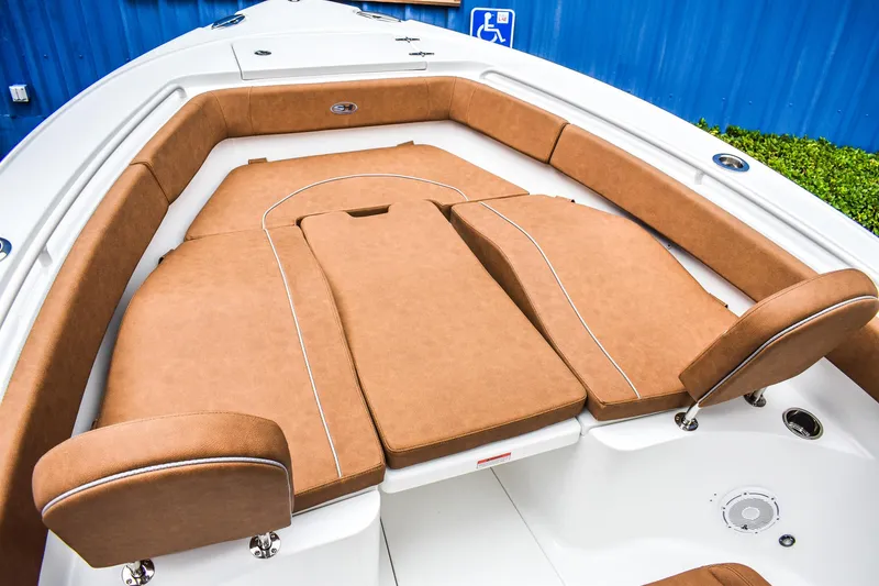 Slide: The Image of 2025 Sea Hunt Ultra 255 SE boat with tan cushioned seating and white deck. - 11