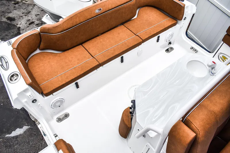 Slide: The Image of 2025 Sea Hunt Ultra 255 SE boat interior with brown seating and white deck. - 3