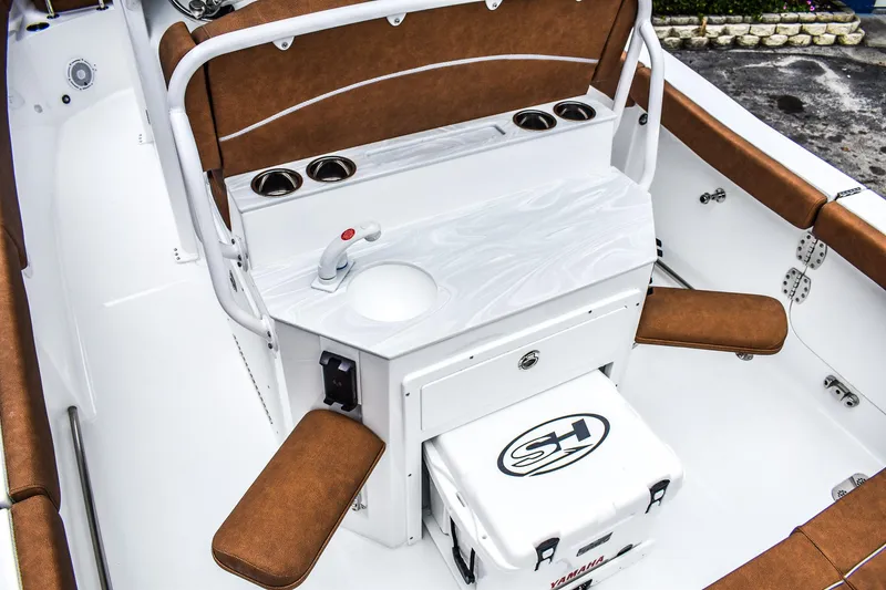 Slide: The Image of 2025 Sea Hunt Ultra 255 SE boat interior with seating, cooler, and cup holders. - 5