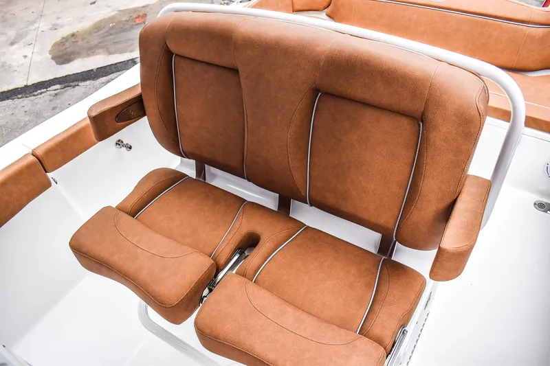 Slide: The Image of 2025 Sea Hunt Ultra 255 SE boat seating with brown upholstery. - 8