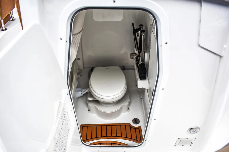 Slide: The Image of 2025 Sea Hunt Ultra 255 SE boat interior with compact marine toilet. - 9