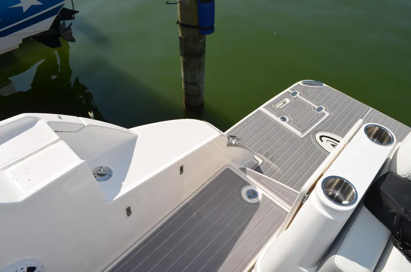 Slide: The Image of 2023 Regal 36 Grande Coupe boat deck with sleek design and cup holders. - 11