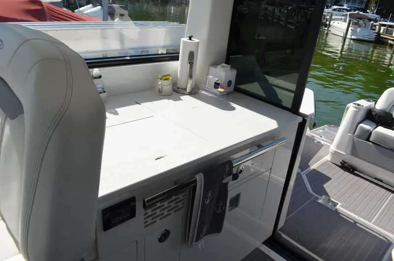 Slide: The Image of 2023 Regal 36 Grande Coupe yacht interior with sleek kitchenette and modern amenities. - 15
