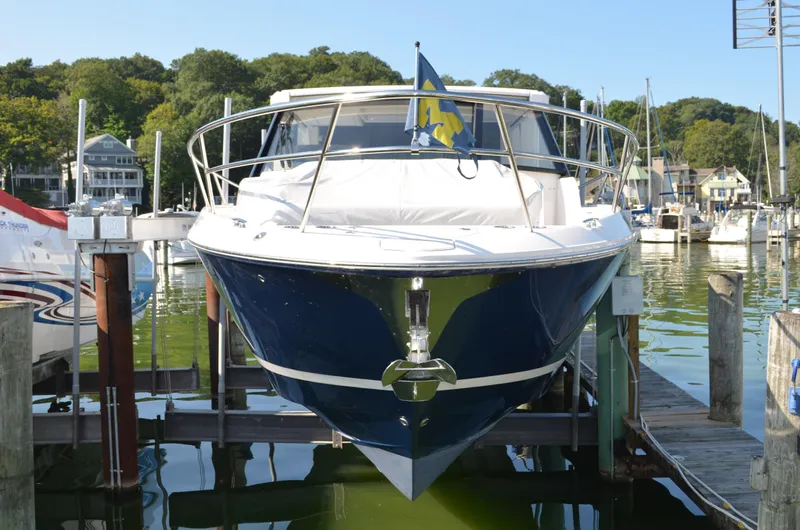 Slide: The Image of 2023 Regal 36 Grande Coupe yacht docked at a marina, front view. - 2