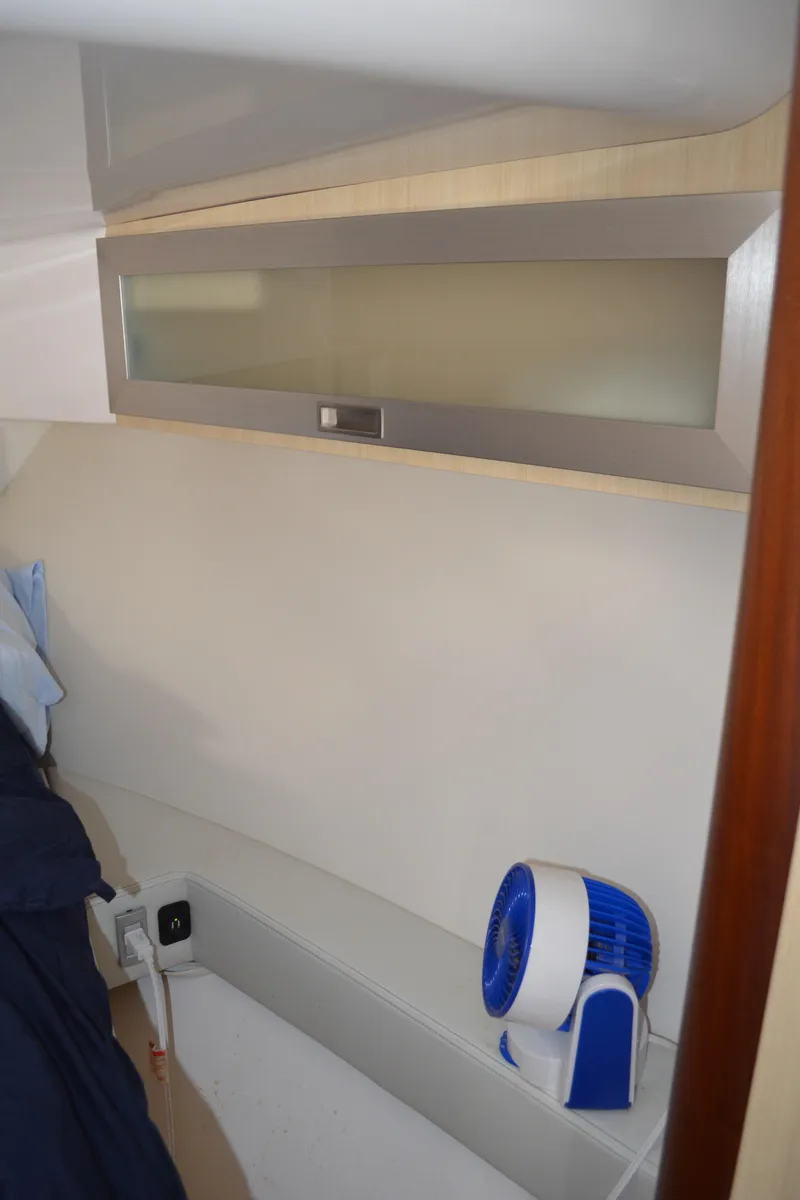 Slide: The Image of 2023 Regal 36 Grande Coupe interior with modern cabinetry and compact fan. - 26