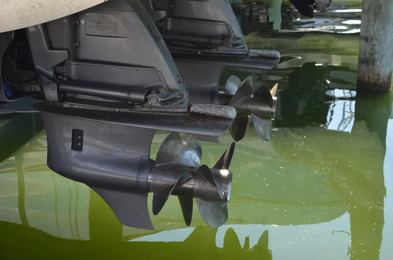 Slide: The Image of 2023 Regal 36 Grande Coupe boat propellers in water, showcasing dual outboard engines. - 5