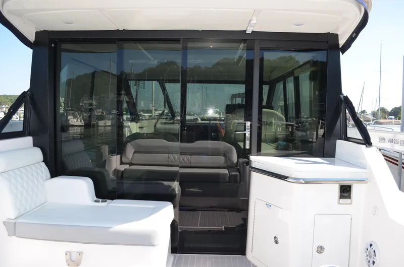 Slide: The Image of 2023 Regal 36 Grande Coupe yacht interior with seating and glass doors. - 6