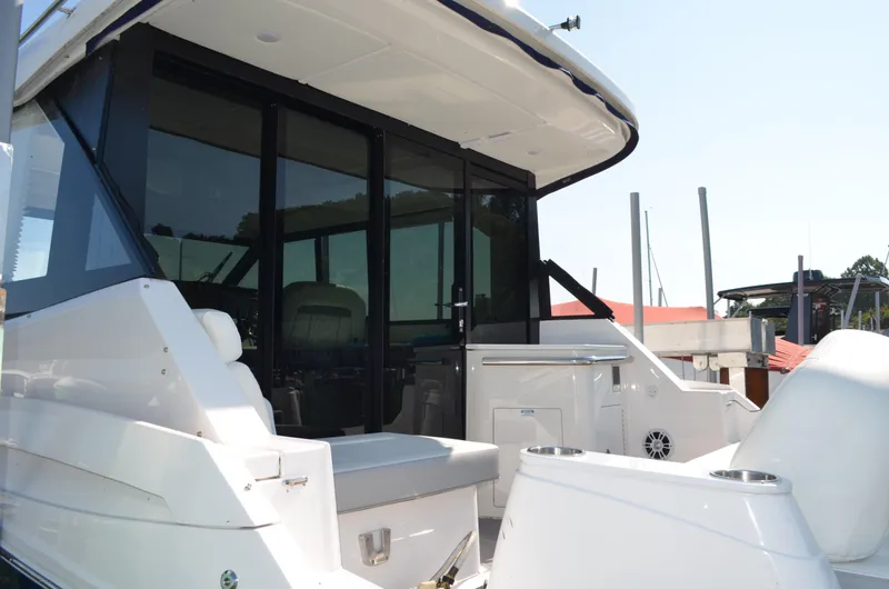 Slide: The Image of 2023 Regal 36 Grande Coupe yacht, rear view with seating and glass doors. - 7