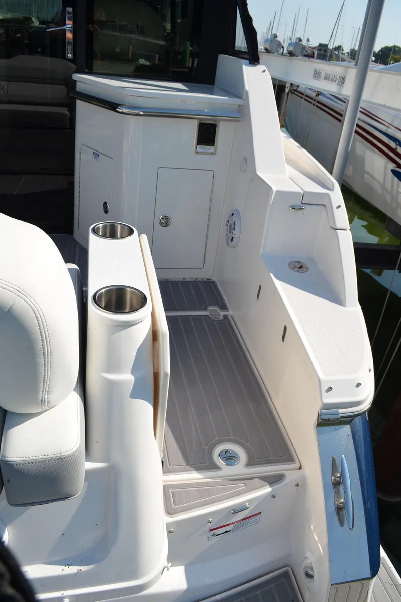 Slide: The Image of 2023 Regal 36 Grande Coupe boat deck with seating and cup holders. - 8