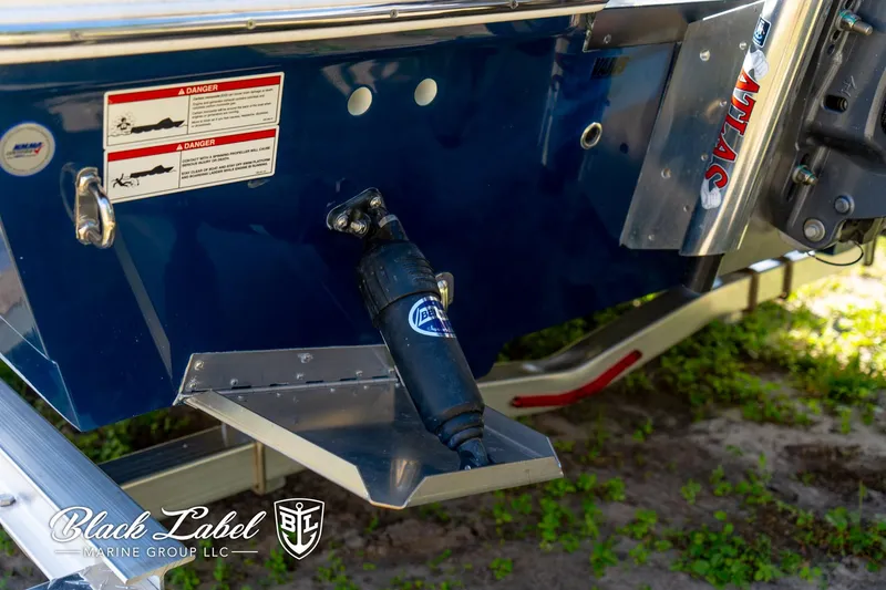 Slide: The Image of 2025 Hewes 18 Redfisher boat stern with trim tab and hydraulic system. - 11