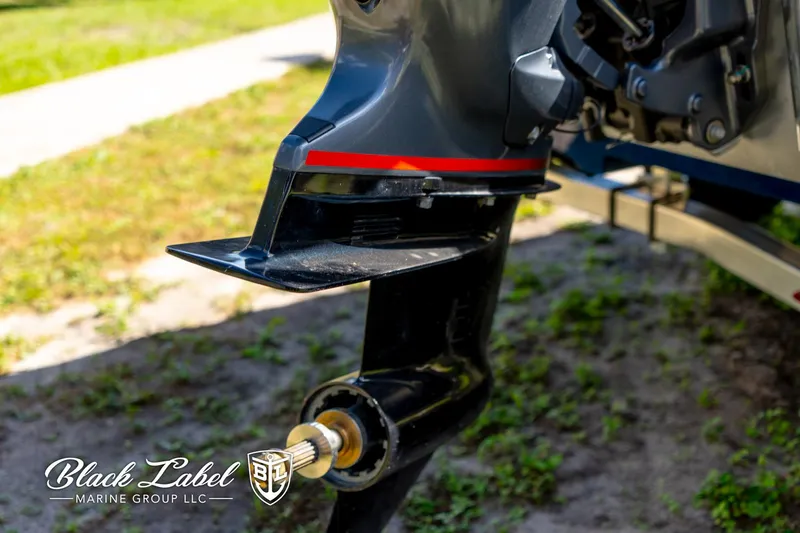 Slide: The Image of 2025 Hewes 18 Redfisher boat motor detail, Black Label Marine Group logo visible. - 15