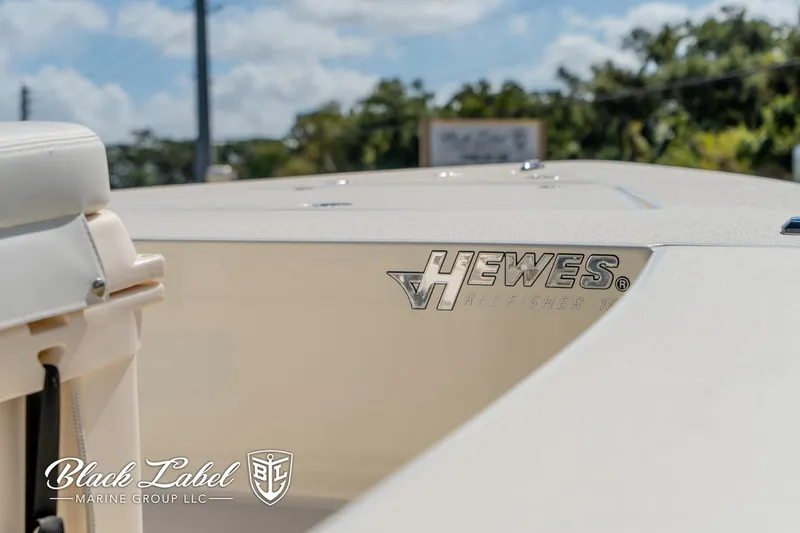 Slide: The Image of 2025 Hewes 18 Redfisher boat detail with logo, sunny day, Black Label Marine Group. - 6